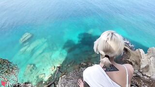 A cute girl passionately sucks dick on the ocean shore in a steamy scene