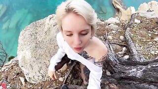 A cute girl passionately sucks dick on the ocean shore in a steamy scene