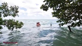 A couple enjoys romantic sex in the blue lagoon