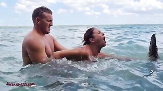 A couple enjoys romantic sex in the blue lagoon