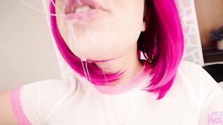 A girl with a pink hair is having fun with a dildo and gets cum on her face