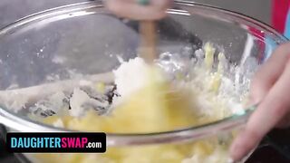Two stepdaughters are busy with a pie for their fathers