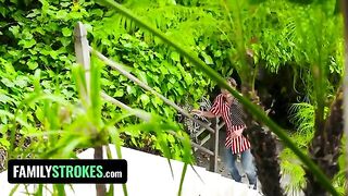 Two playful teens caught in a compromising 4th of July photo shoot