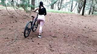 A beautiful woman met a friend while riding her bike
