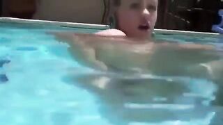 Babe in the pool with dildo in her ass