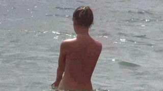A group of people has fun naked on the beach in HD quality
