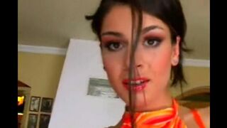 A cute beauty caresses herself in a leather chair, feeling great pleasure