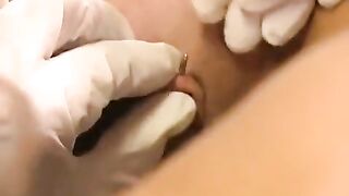 A girl with a pierced clitoris plays with sex toys