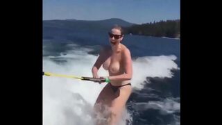 A girl has fun on the water skiing without top