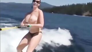 A girl has fun on the water skiing without top