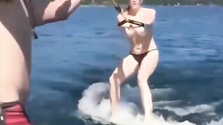 A girl has fun on the water skiing without top
