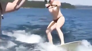 A girl has fun on the water skiing without top
