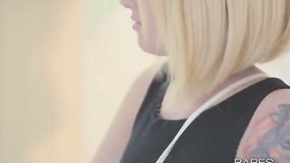 Tattooed woman masturbates alone with her fingers and a glass toy