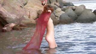 A girl with small boobs gets naked in the rain and has sex