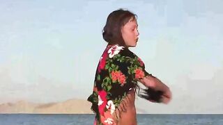 A member shows a girl the secrets of the beach