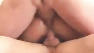 A blonde is having fun with her husband's friend on the couch