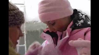 Two girls are having fun in the snow on a cold winter day
