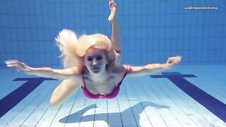 A hot and sexy naked woman swimming in the pool is very nice to look at