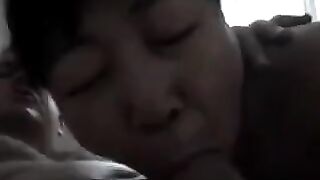 An adult Chinese woman practices on him with her mouth