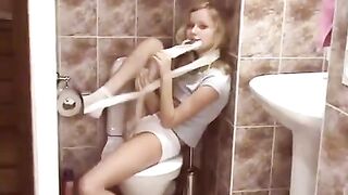 A blonde has sex in the public toilet, showcasing her natural charm