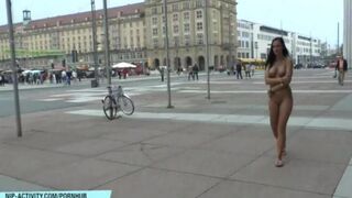 Naked beauty has a walk on the city streets