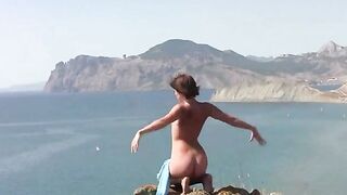 A beautiful body girl poses naked on the sunny beach