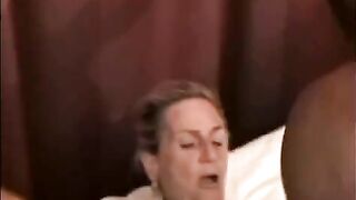A mature woman is having fun with a black man