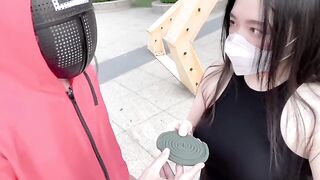 Asian beauty participates in a squid game, showcasing her skills and charm