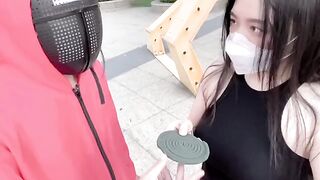 Asian beauty participates in a squid game, showcasing her skills and charm