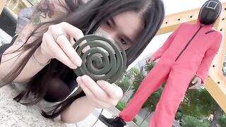 Asian beauty participates in a squid game, showcasing her skills and charm