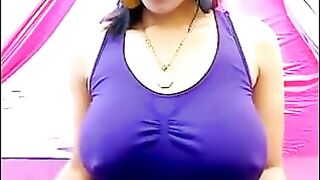 The nipples of an excited brunette stick out through her T-shirt