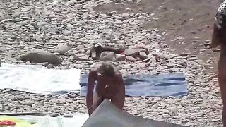 A couple of free-spirited lovers have fun on a naked beach