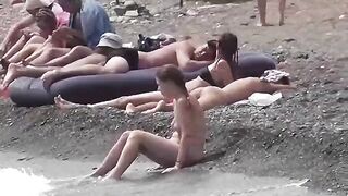 A couple of free-spirited lovers have fun on a naked beach