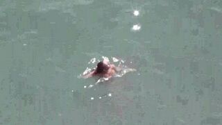 A couple enjoys intimate moments at sea without clothes