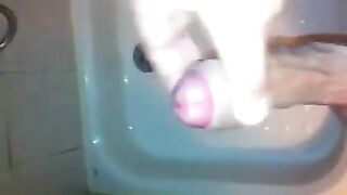 The kid caresses his dick under the jet of water in the shower