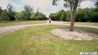 A hot woman is having fun with a guy in the park