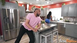 A girl is having fun with a man at her kitchen