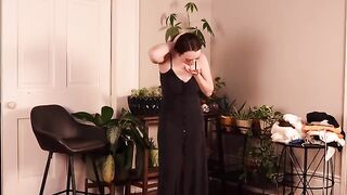A cute girl buys new clothes and tries them on in the bedroom