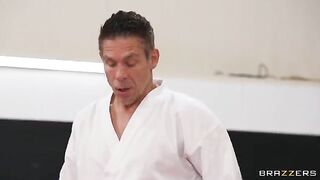A girl is having sex in an awkward pose with her trainer