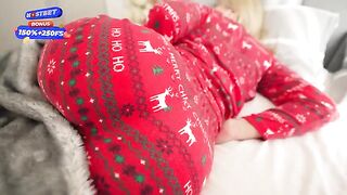 The stepmom receives a Christmas present from her stepson in pajamas