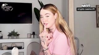 A girl with appetizing forms wears a white sweat suit. It’s very sexy