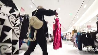 A babe has a daring blowjob in the fitting room and almost gets caught